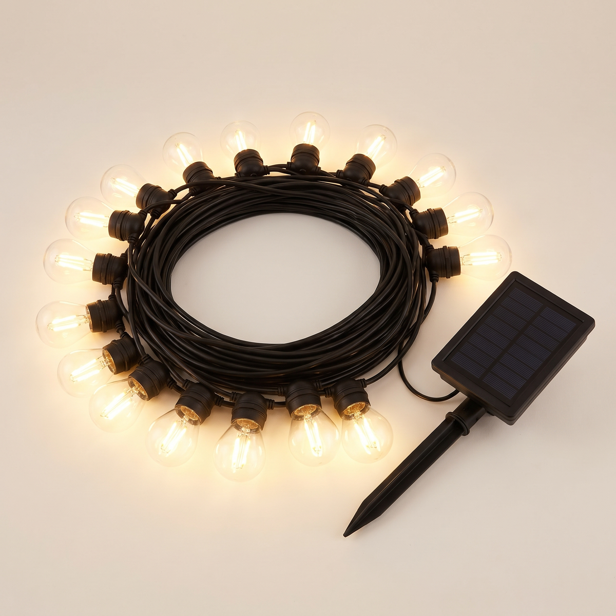 Warm White Solar Festoon Christmas String Lights – 17m, 15 Bulbs – studio view with solar panel