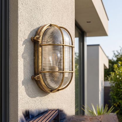 Oval Caged Outdoor Bulkhead Light – mounted outdoors in daylight