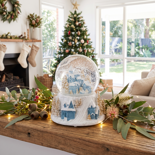 Musical Blue & White Village Snow Globe – 16.5cm – styled in a room
