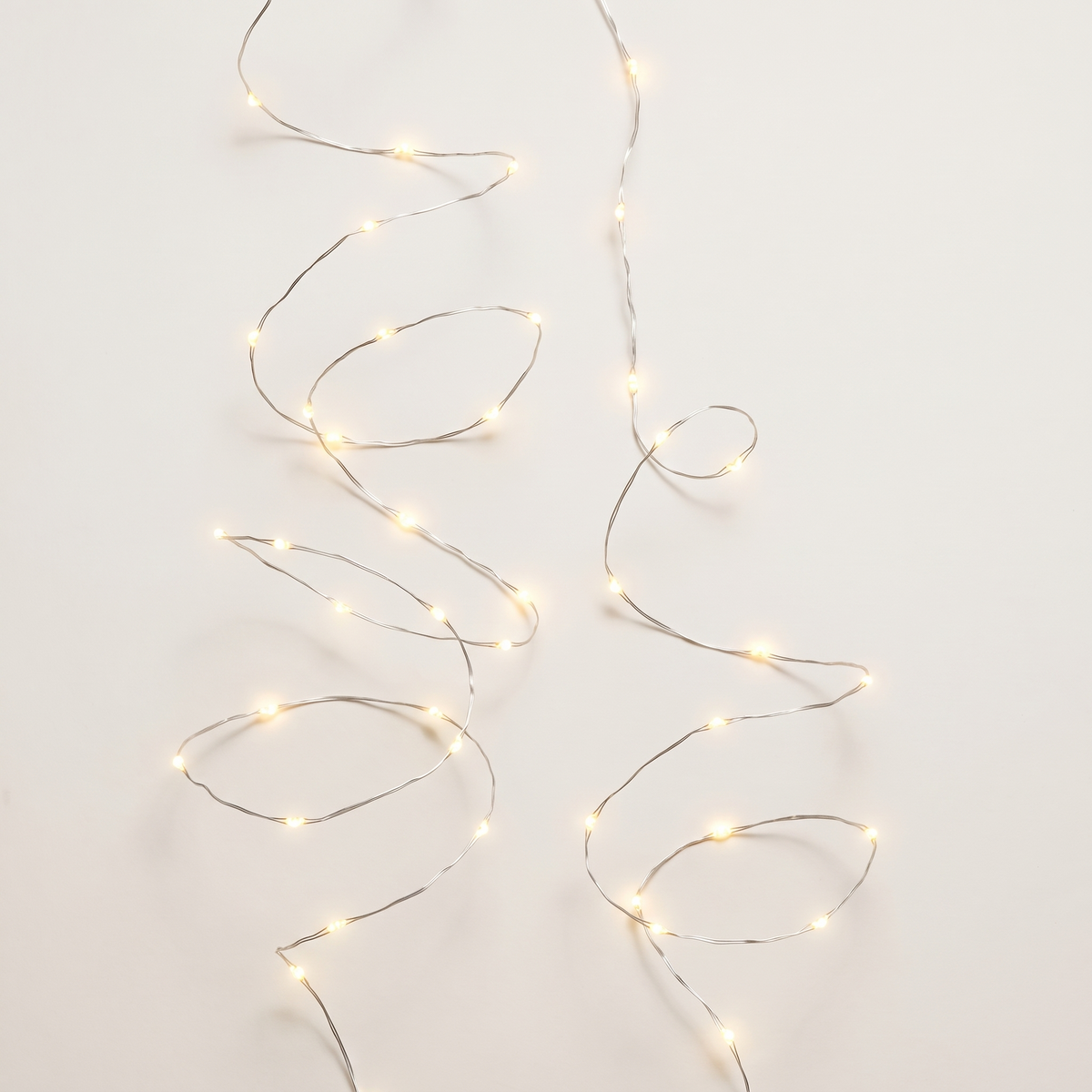 Warm White Twinkle Micro LED Lights on Silver Wire – 100 LED, 4.9m – studio view