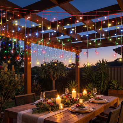 Multicolour LED Icicle Christmas Lights – 20m, 800 LED – glowing over an alfresco pergola at dusk