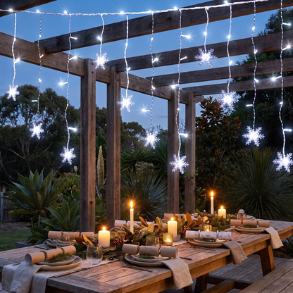 Cool White Snowflake Icicle Christmas Lights – 6m, 160 LED, Solar or Plug – glowing over an alfresco pergola at dusk