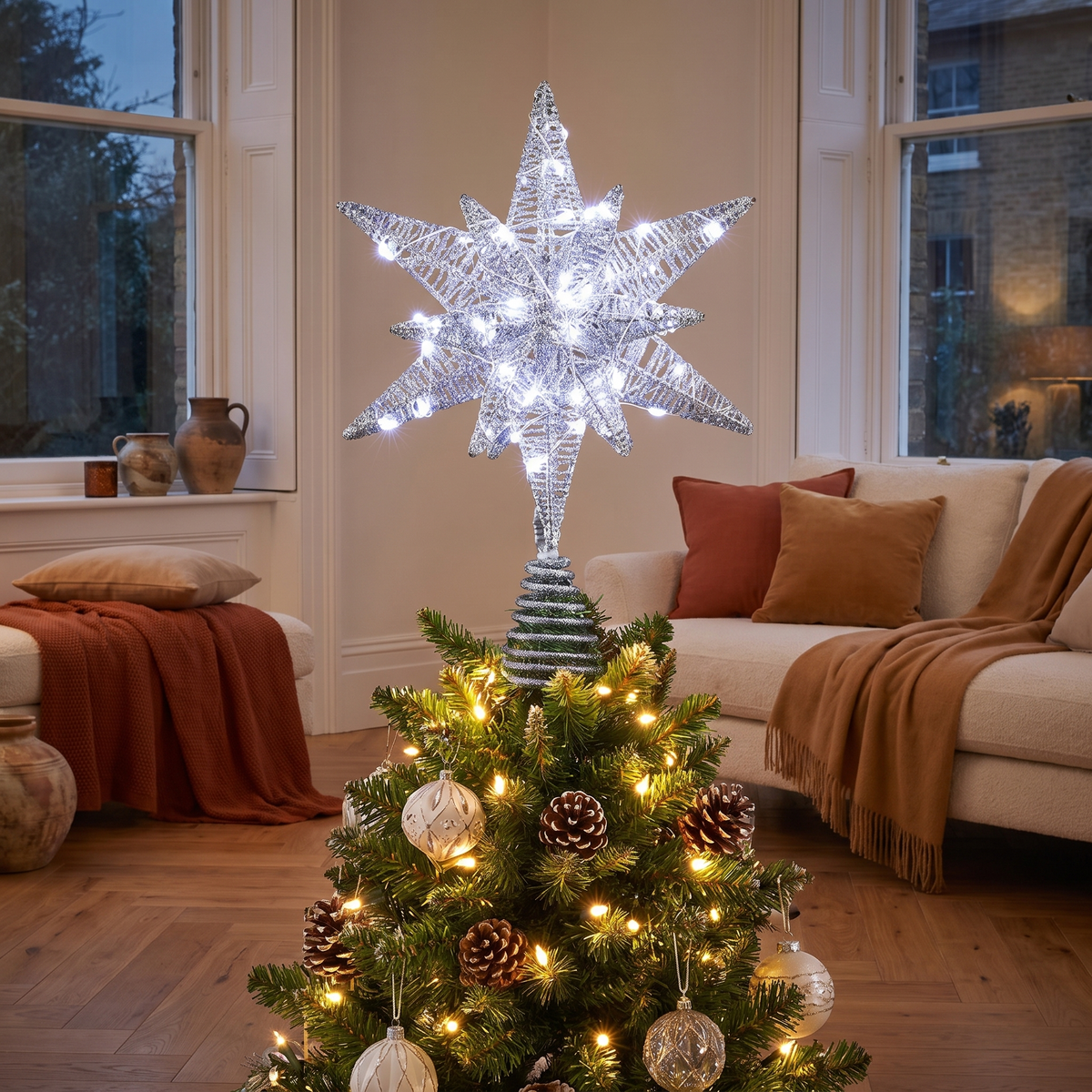 Silver 3D LED Star Christmas Tree Topper – 27cm, 60 LED – glowing in a styled living room at evening