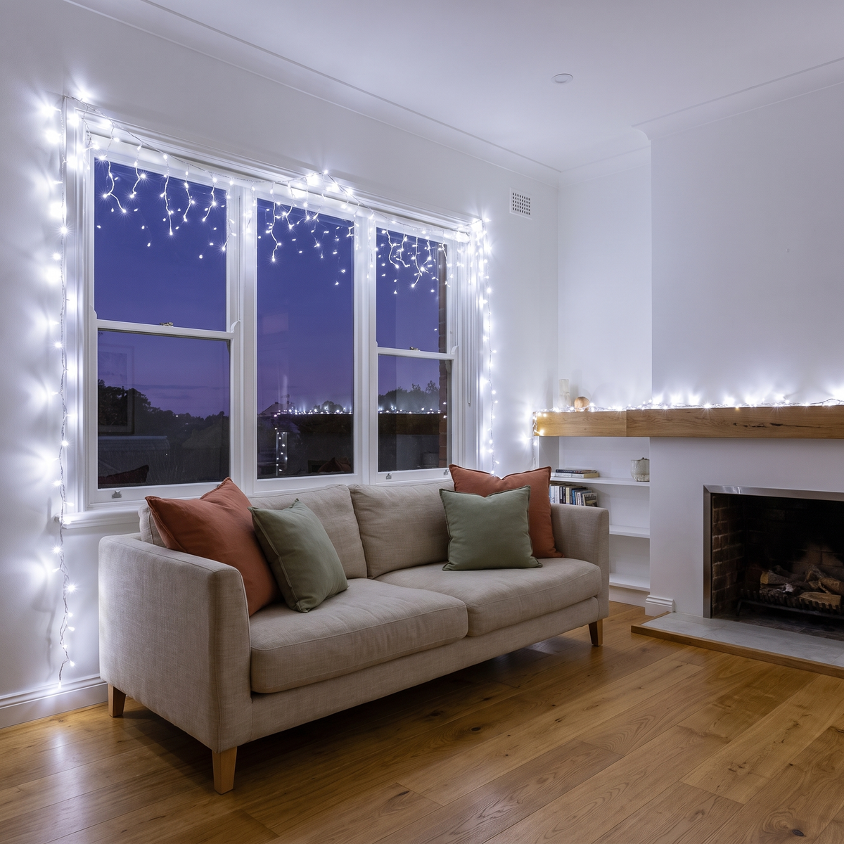 Cool White LED String Christmas Lights – 100m, 500 LED – styled in a bright living room in the evening