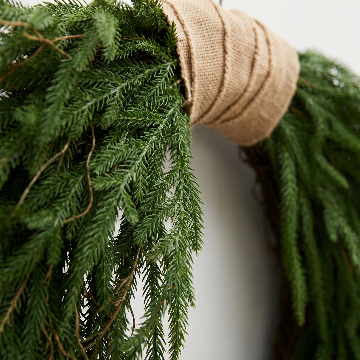 Faux Norfolk Pine Christmas Wreath with Jute Ribbon – 60cm – close-up of the foliage and detail
