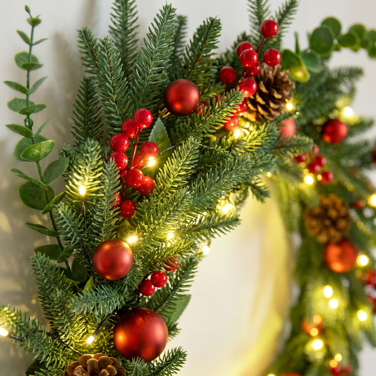 Red Berry & Pine Cone Pre-Lit Christmas Wreath – 60cm, 50 LED – close-up of the foliage and LEDs
